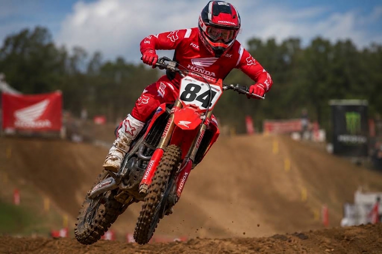 2021 Honda CRF450R jumping on a motocross track with number plate 84