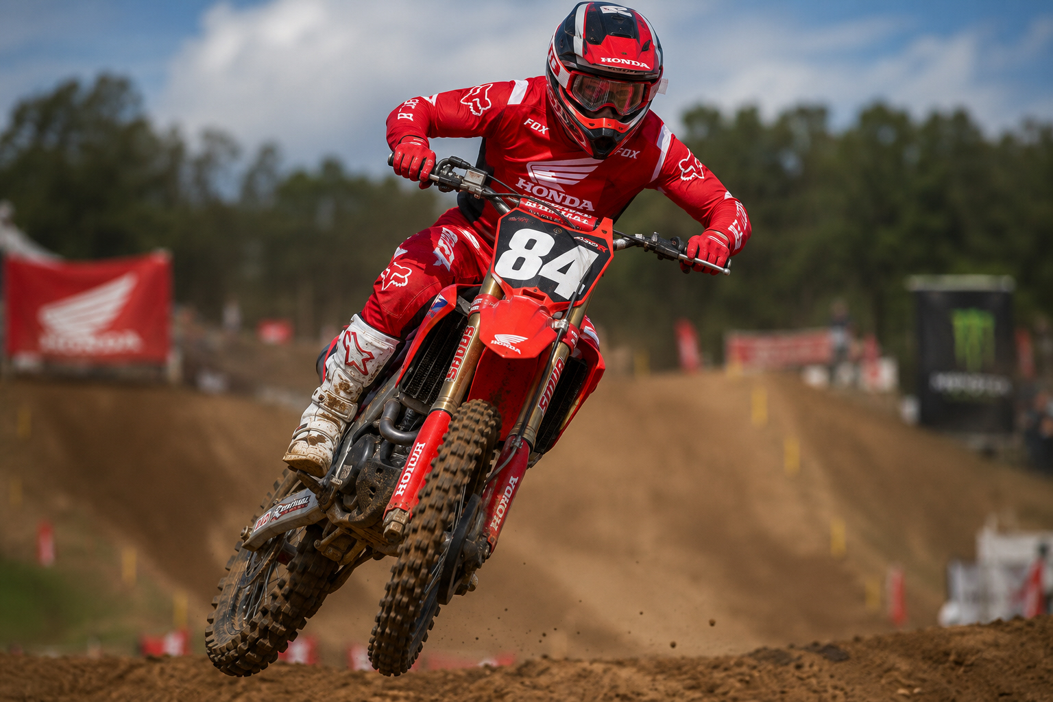 2021 Honda CRF450R jumping on a motocross track with number plate 84